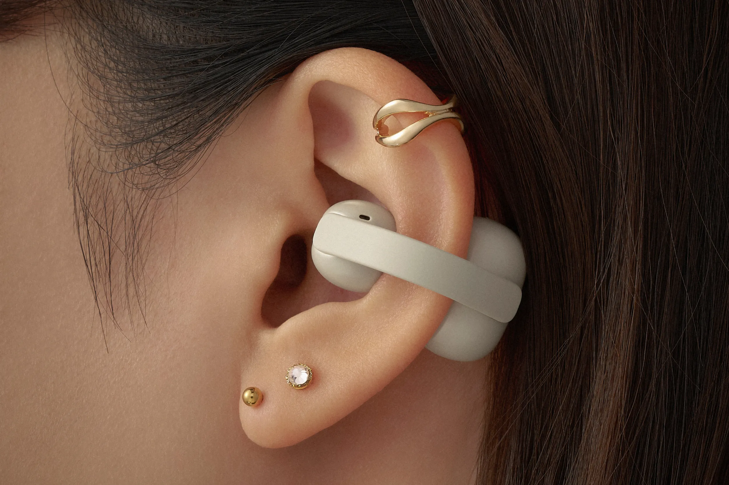 Open ear wireless earbuds representing the Sony LinkBuds Clips design for outdoor activity use